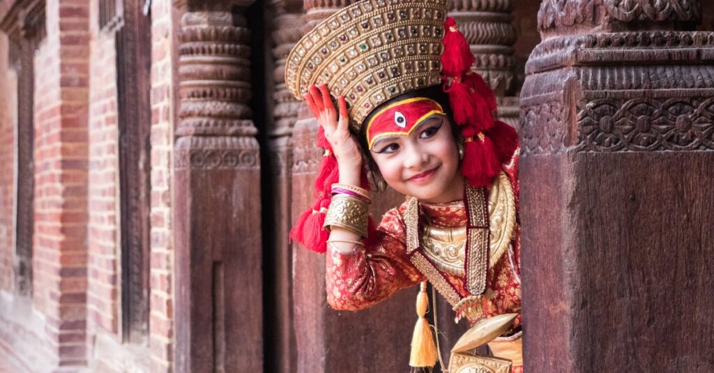 A young girl in traditional Nepalese dress peeks through ornate wooden architecture.